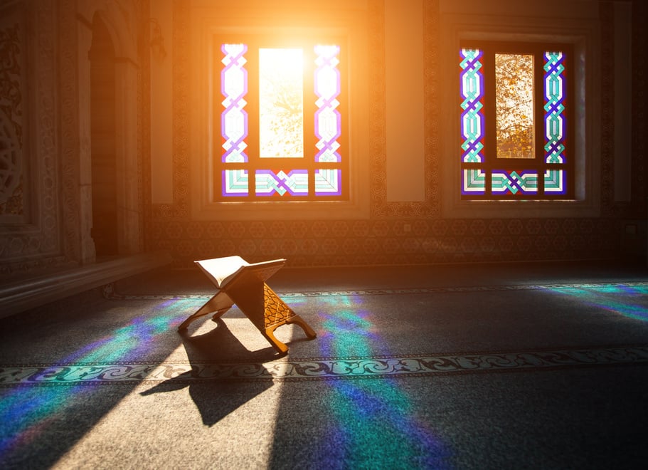 Peaceful mosque interior with sunlight streaming through stained glass and a Quran stand. 
guided Quranic meditation
Quran
Islam
mental health
spiritual growth
relaxation
anxiety
mindfulness
gratitude
connection with Allah
muslim prayer journal

